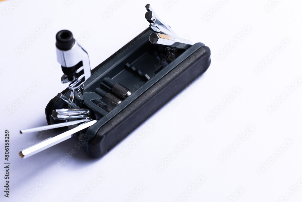 Black bicycle multifunctional multitool unfolded on a white background. Chrome steel tools. Tools for bicycle self-repairing .