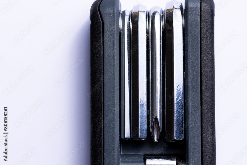Black bicycle multifunctional multitool unfolded on a white background. Chrome steel tools. Tools for bicycle self-repairing .