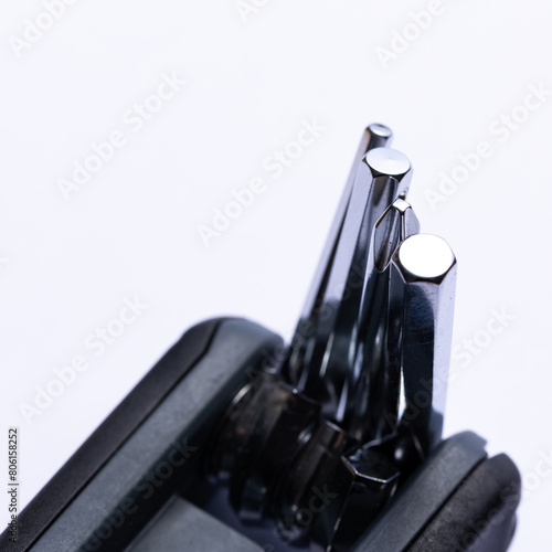 Black bicycle multifunctional multitool unfolded on a white background. Chrome steel tools. Tools for bicycle self-repairing .