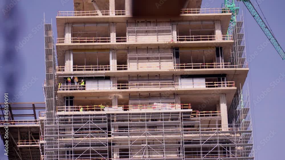 Workers sheathing walls of building facade cladding, walls in house under construction Construction concept of engineer and architect working on construction site with drawing Workers sheathing walls of building facade cladding, walls in house under construction Construction concept of engineer and architect working on construction site with drawing