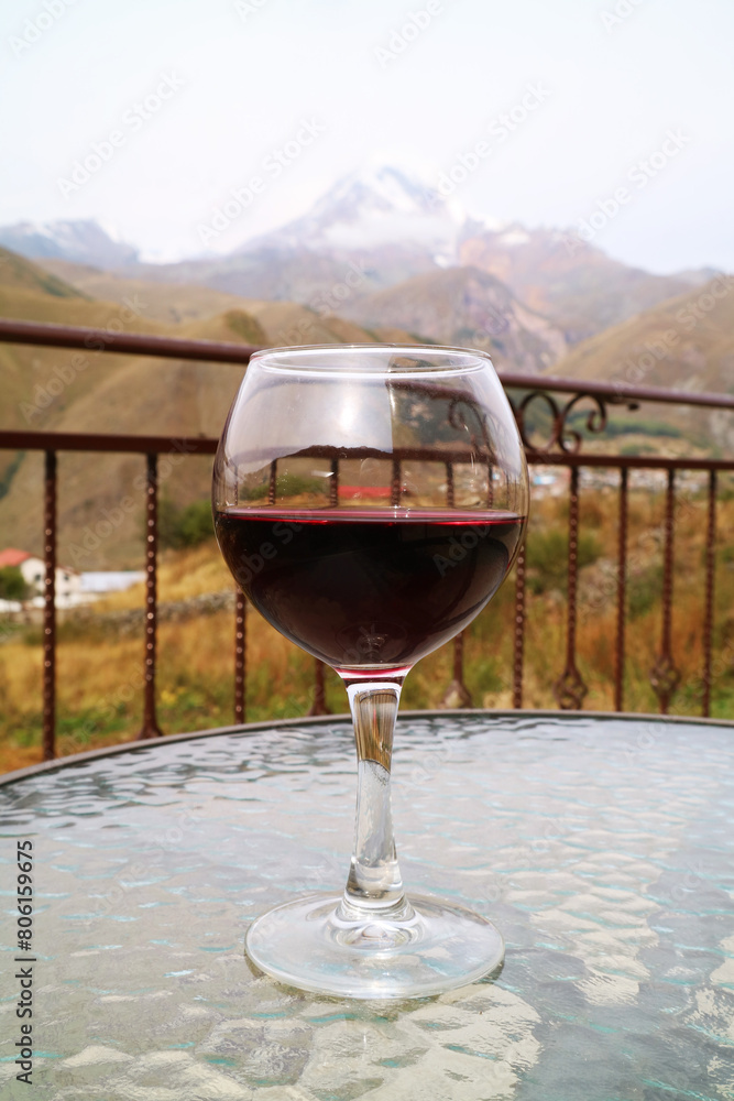Glass of Red Wine on a Table with Mount Kazbek of Georgia in the Backdrop