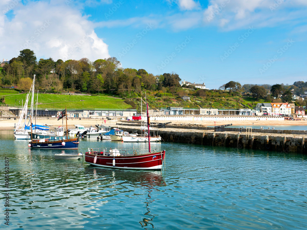 Fototapeta premium Sailboats at anchor in calm harbour waters on an April morning 