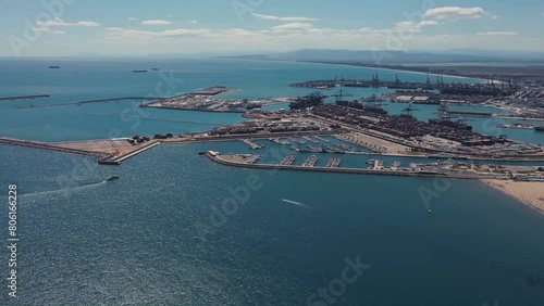 Drone flight over the Valencia sea and seaport. Valencia beach and seaport by drone. Valencia city taken by drone. Sunny day Beach by drone. People rest at the beach in a sunny day.
