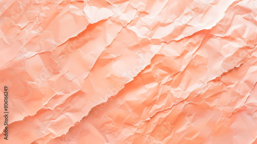 The texture of crumpled paper in the fashionable color 2024 peach fuzz. Horizontal banner. Pastel peach background. photo