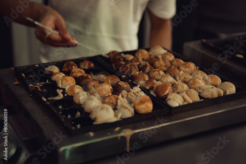 Skilled Chef Masterfully Prepares Dessert Takoyaki Styled as Pancake Bites Served Fresh at an Evening Street Market