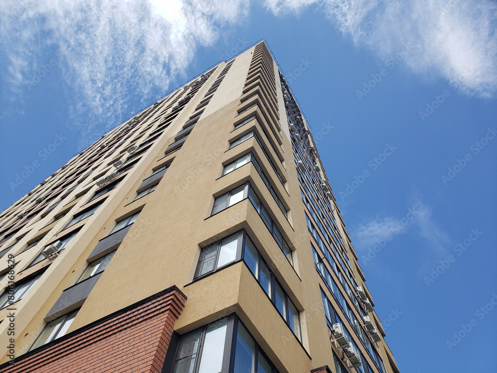 high-rise apartment building against the blue sky. Typical developments in residential areas. high-rise apartment building against the blue sky. Typical developments in residential areas.
