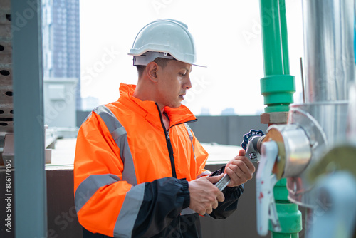 The engineer checks and adjusts the valve to allow the amount of water to flow through the CW bile pipe. photo