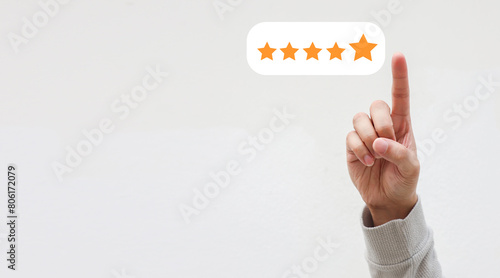 close up on customer man hand pressing o gold five star rating feedback icon and choose the best level rank for give score to review the business and service concept