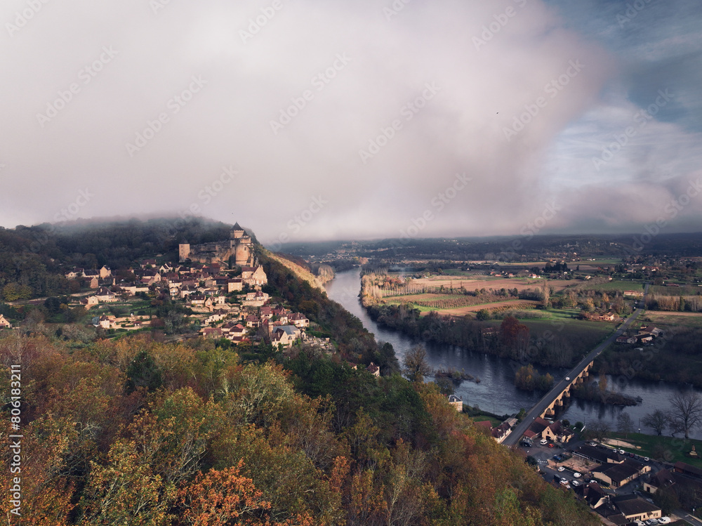 Panoramic view of Chateau de Castelnaud and Chateau de Beynac in the Dordogne valley, cloudy weather heralding a storm. Panoramic view of Chateau de Castelnaud and Chateau de Beynac in the Dordogne valley, cloudy weather heralding a storm.