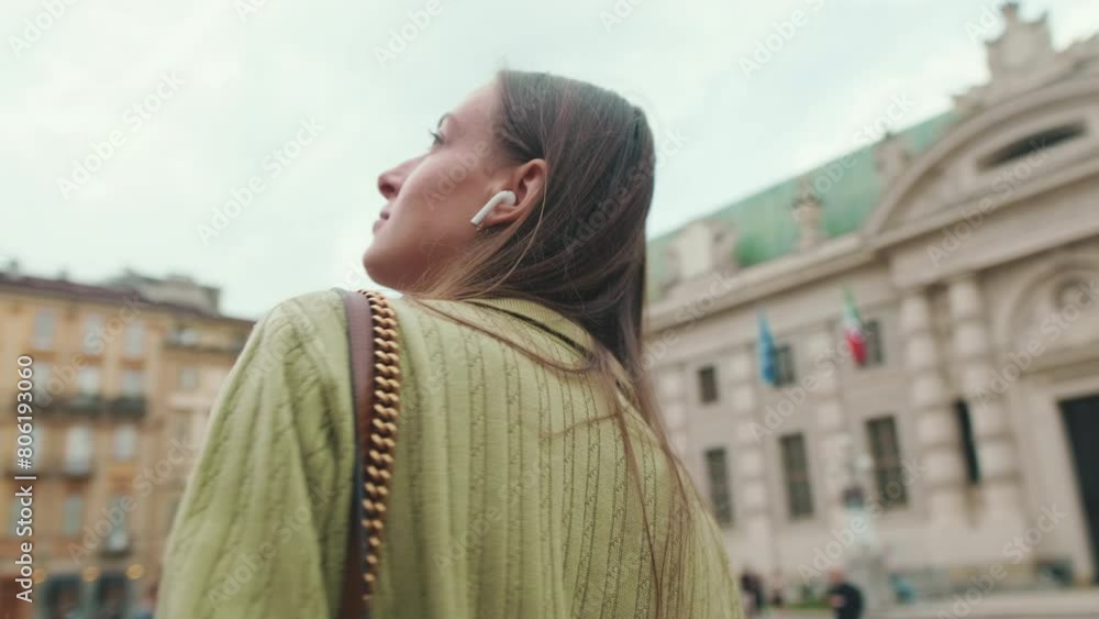 Young woman in wireless earphone travels through Italy Young woman in wireless earphone travels through Italy
