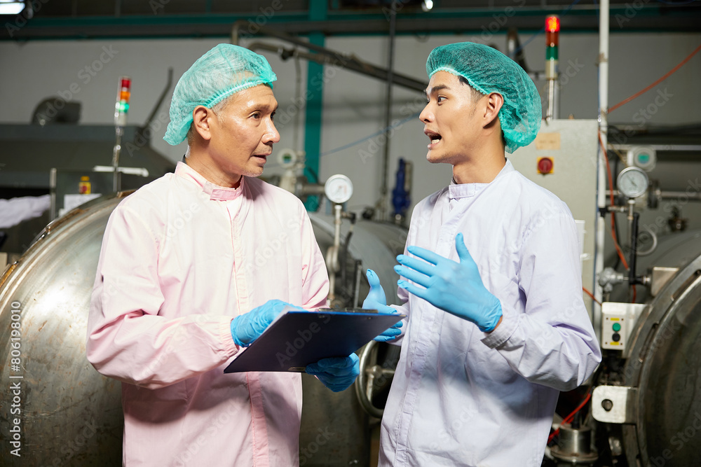 male workers meeting and talking about work or project in the beverage factory male workers meeting and talking about work or project in the beverage factory