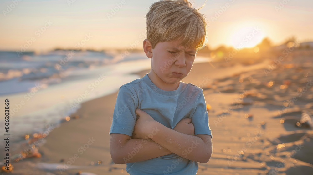 upset boy holding his sore stomach on the beach, diarrhea, poisoning, rotavirus, abdominal pain, tummy, sick child, kid, baby, sea, summer, illness, nausea, painful, ill, disease, stomach ache, health