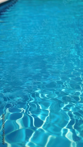 Close view of clear beautiful blue flowing water in swimming pool. Slow motion vertical video. Water surface. Travel and vacation concept. Summer © Александр Ткачук