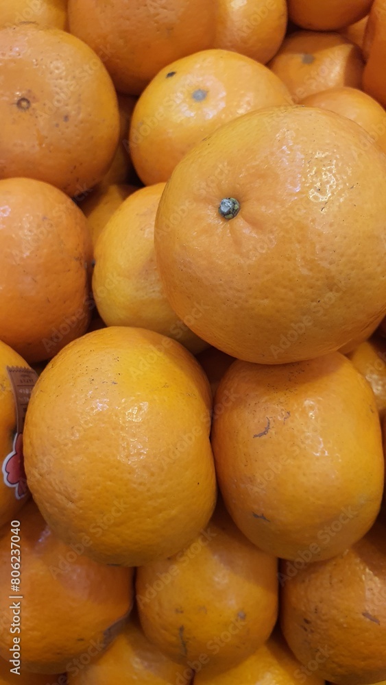 Close up pile of tasty fresh oranges sold at the market as a background. Close up pile of tasty fresh oranges sold at the market as a background.