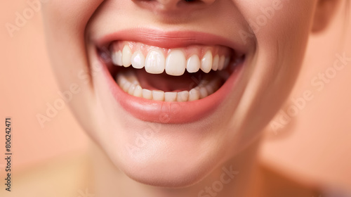 Bright, joyful smile showing healthy white teeth, set against a soft peach background.