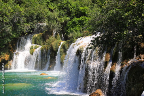 cascade waterfall among large stones in Krka Landscape Park  Croatia in spring or summer. The big beautiful Croatian waterfalls  mountains and nature.