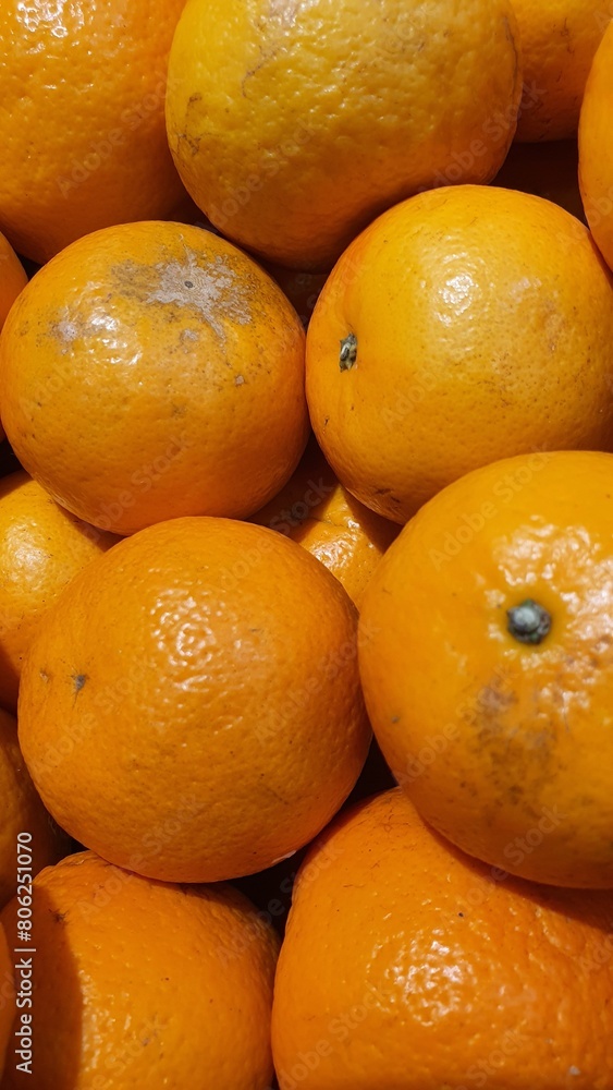 Close up pile of tasty fresh oranges sold at the market as a background. Close up pile of tasty fresh oranges sold at the market as a background.