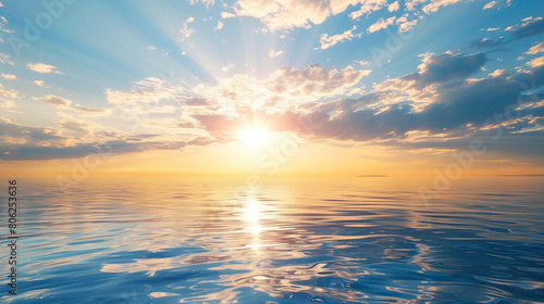 The sun is shining on the ocean  creating a beautiful and serene scene. The water is calm and the sky is clear  making for a perfect day to relax and enjoy the view