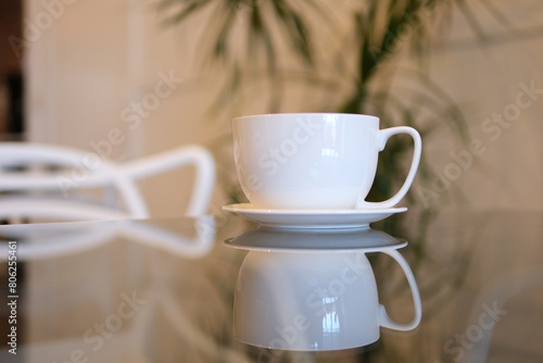 Cup of latte coffee in the shape of heart and coffee beans on old wooden background