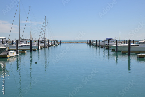 Boats at dock in the calm harbor © BradleyWarren