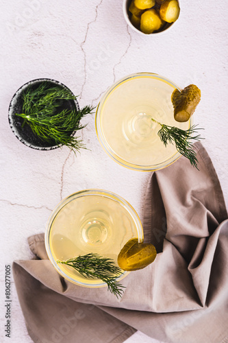 Refreshing pickles martini cocktails in glasses on the table top and vertical view