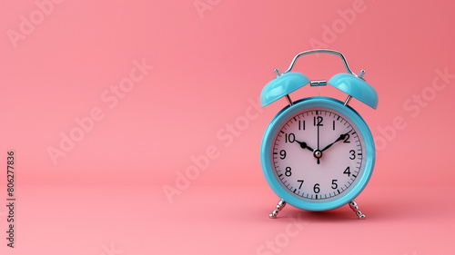 Blue alarm clock on pastel pink background. minimal concept.