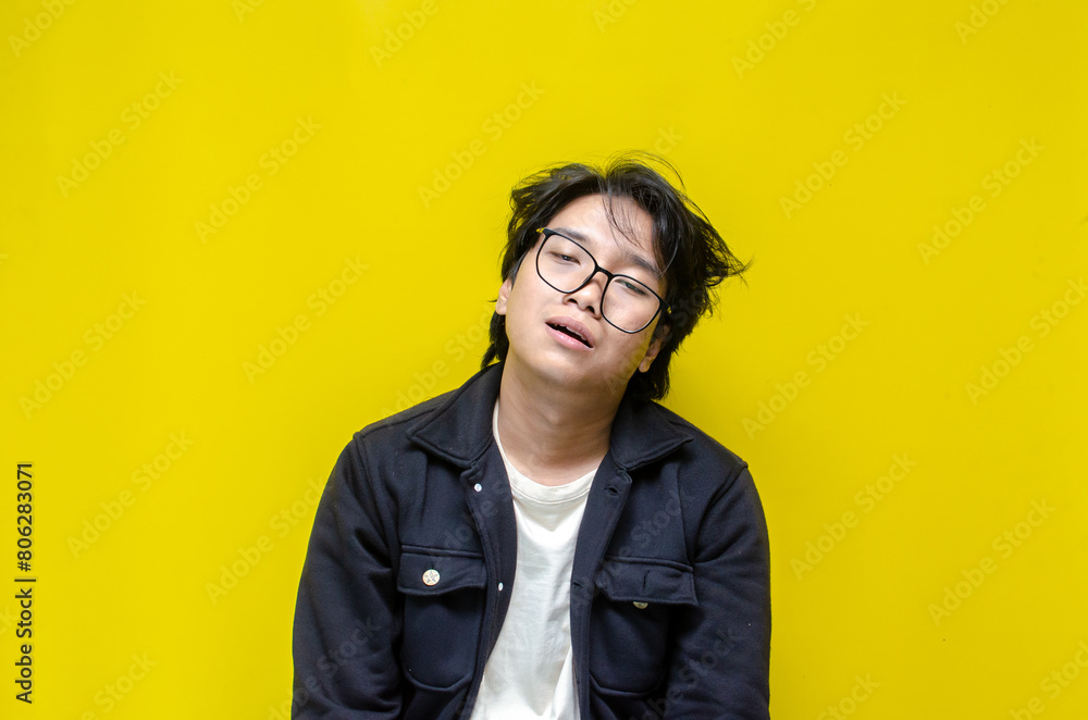 Fototapeta premium asian man looks depressed and messed up. Irritated man bites lips and scratches head. stressed over work concept.