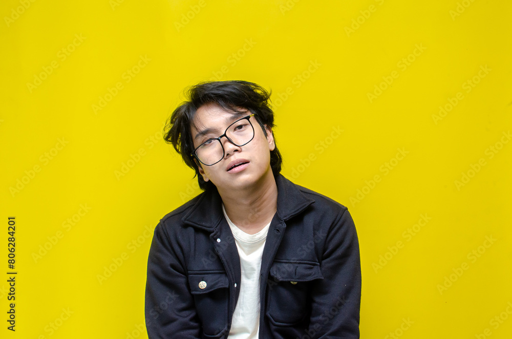 Fototapeta premium asian man looks depressed and messed up. Irritated man bites lips and scratches head. stressed over work concept.