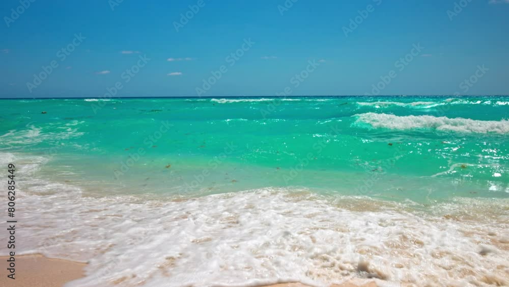 Beautiful view of large waves from the Caribbean Sea crashing onto the sandy beaches of Mexico.