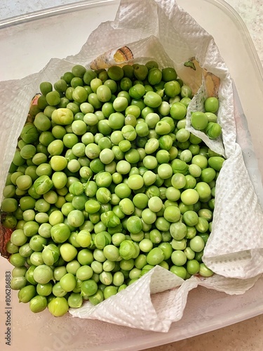 green peas, fresh vegetables, picked peas in the garden, washed and harvested vegetables