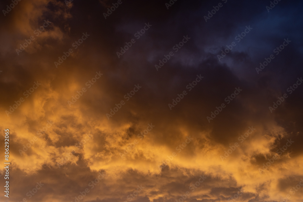 Dramatic clouds glowing at sunset, on a spring evening Dramatic clouds glowing at sunset, on a spring evening