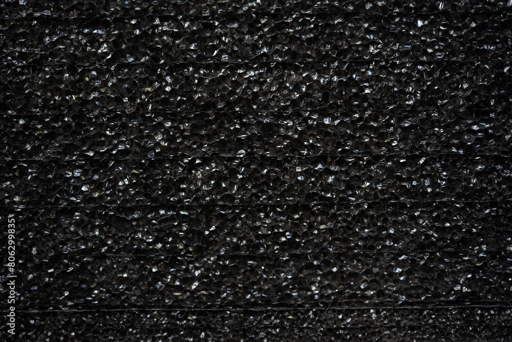 Black porous porous foam background. Background texture of black foam rubber Black porous porous foam background. Background texture of black foam rubber