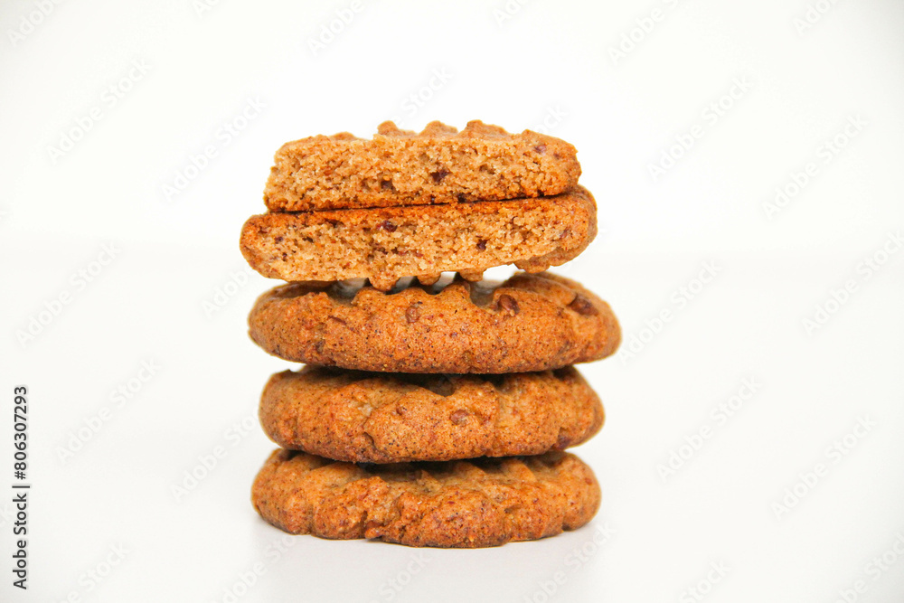 Stack of freshly baked peanut butter cookies. The top cookie is broken in half to see the texture of cookies. White background. Stack of freshly baked peanut butter cookies. The top cookie is broken in half to see the texture of cookies. White background.