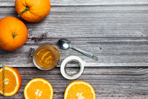 Tasty and healthy homemade orange marmalade. Top view of a table with a jar of homemade orange marmalade.