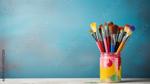 A vibrant array of paintbrushes fills a jar, ready for a masterpiece to be created photo