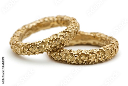 Close up of elegant gold wedding rings on a clean white background in a macro shot