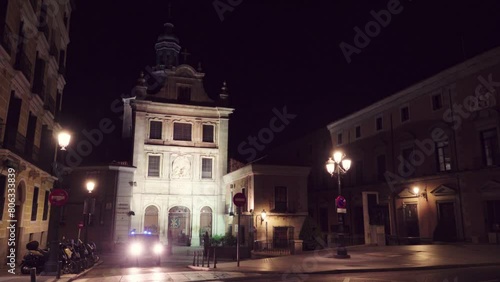 MADRID, SPAIN - DECEMBER 4 2017: Cathedral Church of the Armed Forces. Police car. Monument to Victoria Eugenia and Alfonso XIII. Night illumination. photo