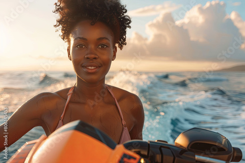African American woman in bikini standing on an jet ski
 photo