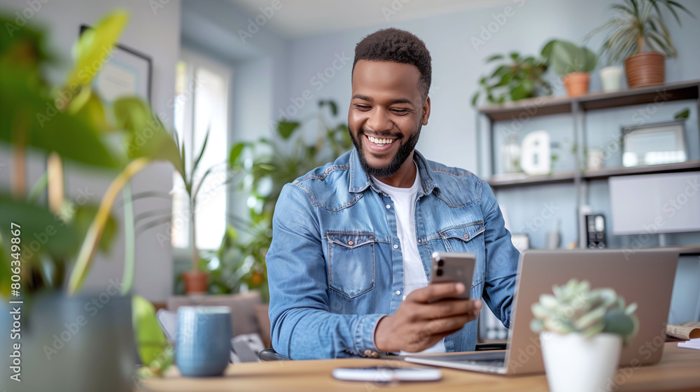 Happy African American Man Using Smartphone in Home Office Happy African American Man Using Smartphone in Home Office