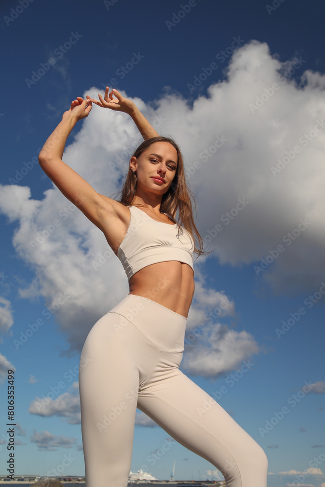 young athletic woman in white tracksuit by the sea young athletic woman in white tracksuit by the sea