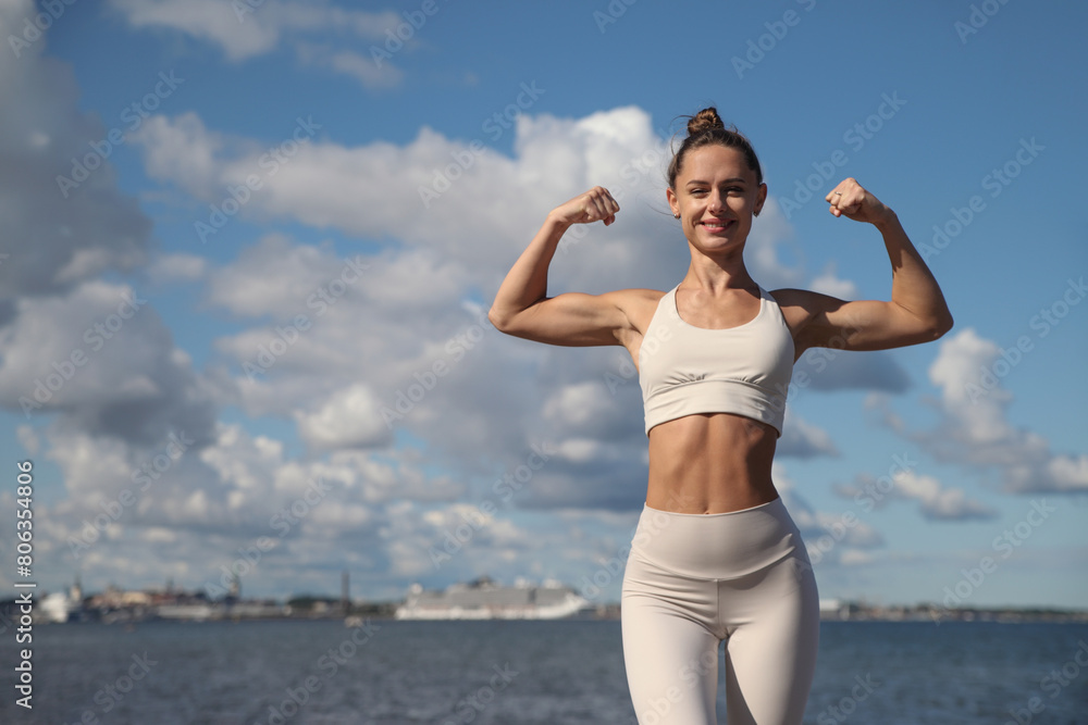 young athletic woman in white tracksuit by the sea young athletic woman in white tracksuit by the sea