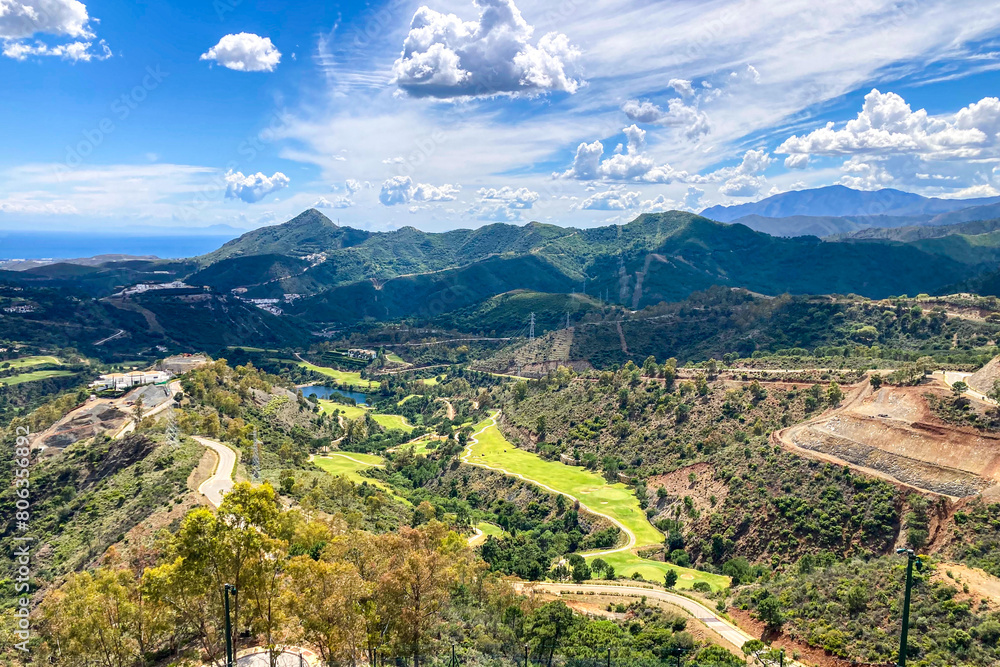 Clouds on blue sky over golf fields, Marbella, Spain