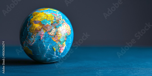 A globe is sitting on a blue surface