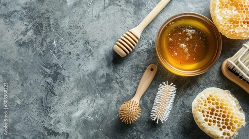 Small glass bowl with honey, wooden hairbrush and loofah sponges. Natural hair treatment, sugaring hair removal and homemade spa recipe.Top view, copy space. photo