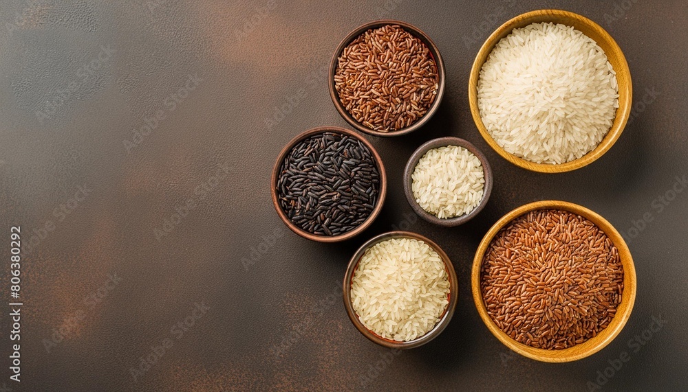 assortment of dry rice in bowls on a dark brown background top view flat lay copy space