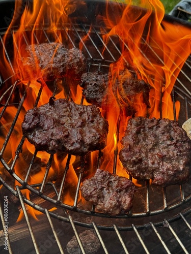 Beef meat barbecue burgers prepared on bbq fire flame.