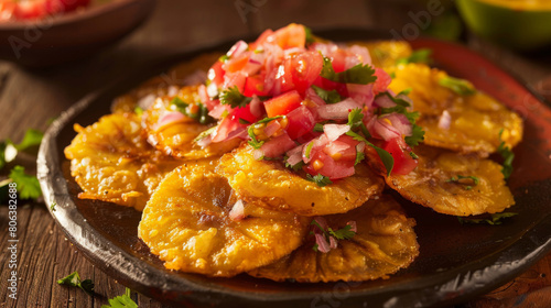 Delicious colombian patacones with fresh tomato and onion salsa, served as a savory latin american appetizer on a rustic plate photo