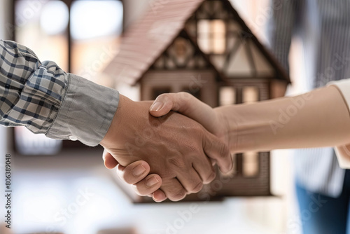 Estate agent shaking hands with his customer after contract signature photo