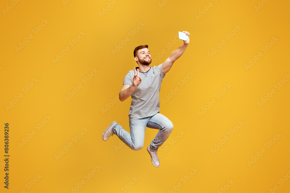 A man is captured mid-jump with a frisbee in hand, showcasing athleticism and fun outdoor activity.