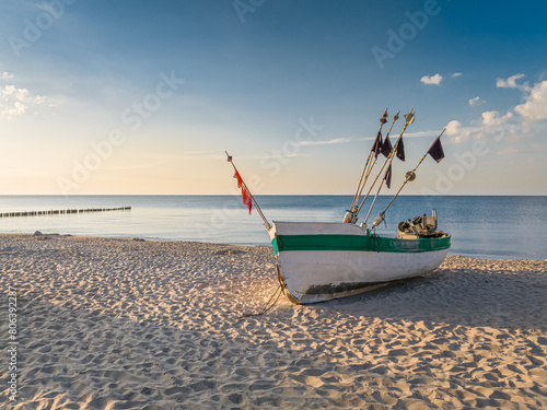 Fototapeta Naklejka Na Ścianę i Meble -  Fishing boat by the Baltic Sea in summer at sunrise
